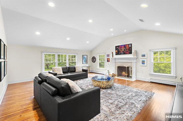 6 Lauren Pond Ct, Demarest, NJ 07627 - living area with a baseboard heating unit, vaulted ceiling, plenty of natural light, light wood-style flooring, and recessed lighting