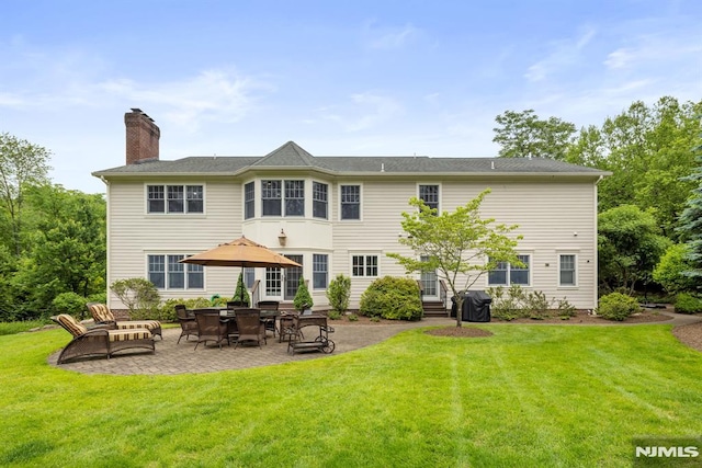 6 Lauren Pond Ct, Demarest, NJ 07627 - back of property with a patio, a chimney, and a lawn