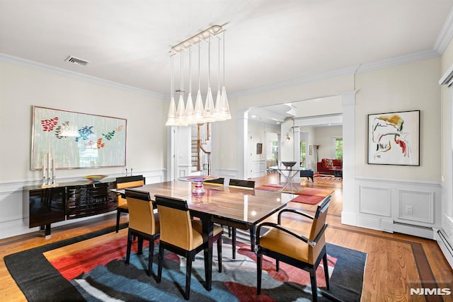 6 Lauren Pond Ct, Demarest, NJ 07627 - dining space featuring wood finished floors, ornamental molding, decorative columns, a decorative wall, and wainscoting