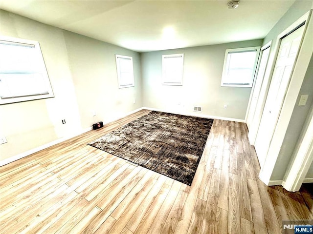 194 Elm Ave, Teaneck, NJ 07666 - unfurnished bedroom featuring wood finished floors, baseboards, and two closets