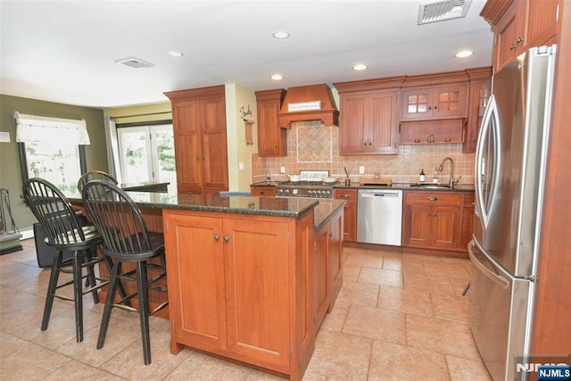 126 Darrow Dr, North Haledon, NJ 07508 - kitchen with appliances with stainless steel finishes, premium range hood, a sink, a kitchen island, and backsplash