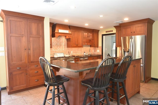 126 Darrow Dr, North Haledon, NJ 07508 - kitchen featuring stainless steel refrigerator with ice dispenser, custom range hood, a sink, stove, and brown cabinetry