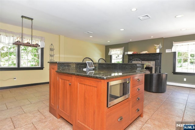 126 Darrow Dr, North Haledon, NJ 07508 - kitchen with stainless steel microwave, a baseboard heating unit, recessed lighting, a kitchen island, and baseboards