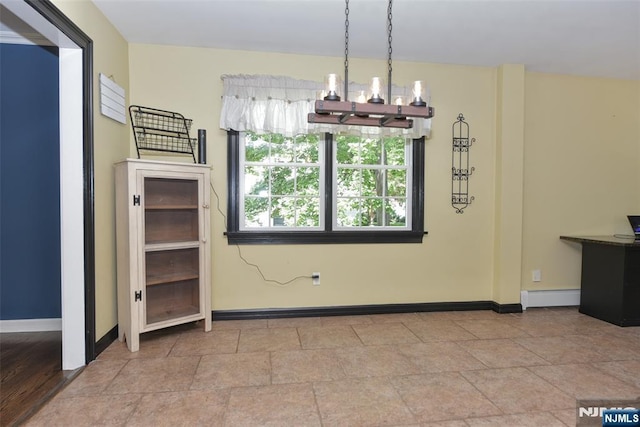 126 Darrow Dr, North Haledon, NJ 07508 - unfurnished dining area featuring a baseboard radiator, baseboards, a chandelier, and stone finish flooring
