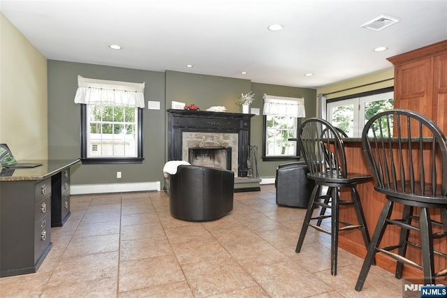 126 Darrow Dr, North Haledon, NJ 07508 - living area with recessed lighting, baseboards, a fireplace with raised hearth, a baseboard heating unit, and light tile patterned floors