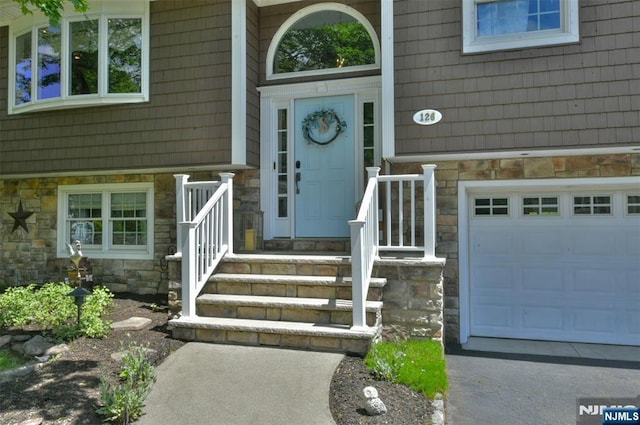 126 Darrow Dr, North Haledon, NJ 07508 - doorway to property with stone siding and an attached garage