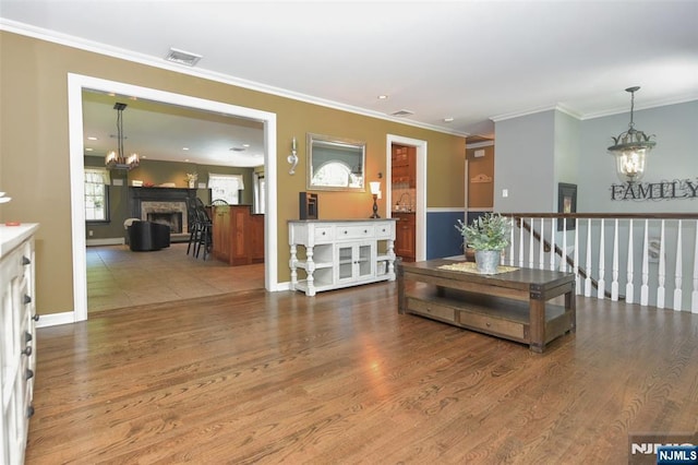 126 Darrow Dr, North Haledon, NJ 07508 - living area with a chandelier, wood finished floors, a fireplace, crown molding, and baseboards