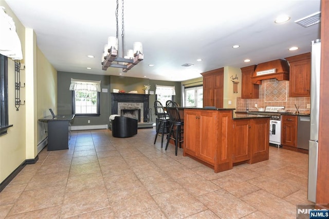 126 Darrow Dr, North Haledon, NJ 07508 - kitchen with custom range hood, high end range, dark countertops, backsplash, and recessed lighting