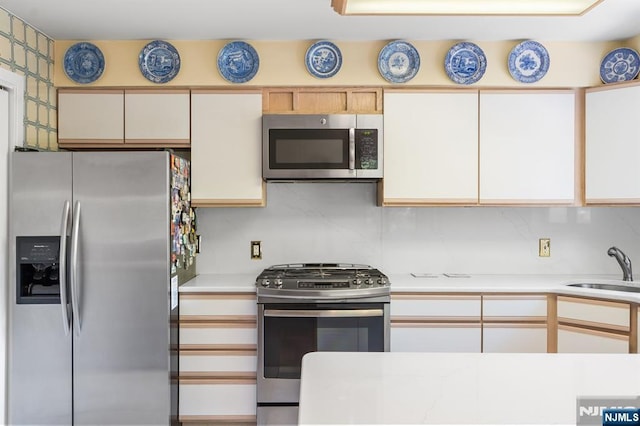 506 Teal Plz, Secaucus, NJ 07094 - kitchen with stainless steel appliances, light countertops, a sink, and tasteful backsplash