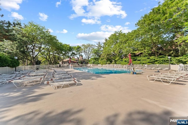 506 Teal Plz, Secaucus, NJ 07094 - community pool with a patio and view of wooded area