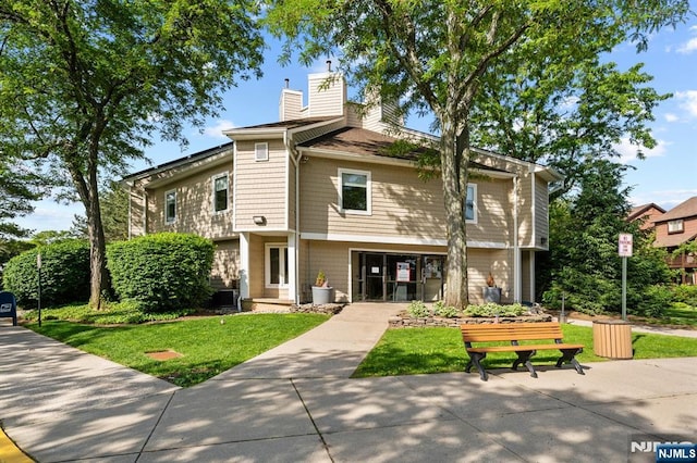 506 Teal Plz, Secaucus, NJ 07094 - rear view of house with a chimney and a lawn