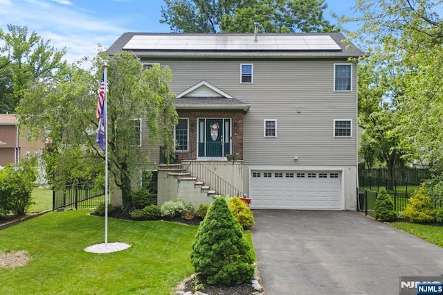 41 Sycamore Ave, Hillsdale, NJ 07642 - traditional home with an attached garage, roof mounted solar panels, driveway, stairway, and brick siding