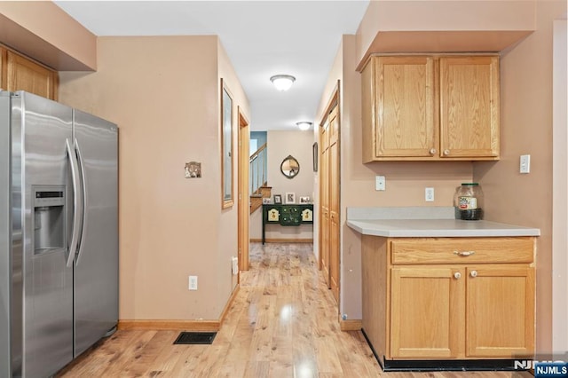 41 Sycamore Ave, Hillsdale, NJ 07642 - kitchen with stainless steel fridge with ice dispenser, light wood finished floors, light brown cabinetry, and light countertops