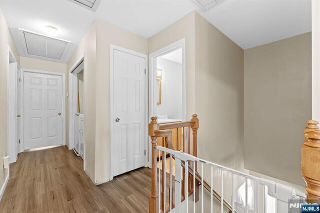 41 Sycamore Ave, Hillsdale, NJ 07642 - corridor with an upstairs landing, attic access, wood finished floors, and baseboards