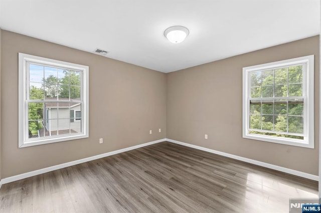 41 Sycamore Ave, Hillsdale, NJ 07642 - empty room with baseboards, plenty of natural light, and wood finished floors