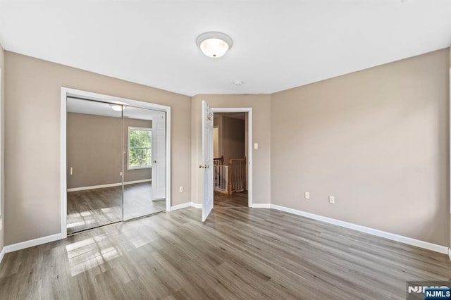 41 Sycamore Ave, Hillsdale, NJ 07642 - unfurnished bedroom with wood finished floors, baseboards, and a closet