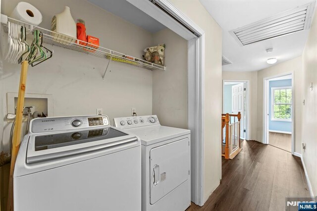 41 Sycamore Ave, Hillsdale, NJ 07642 - washroom with washer and dryer, dark wood-style flooring, and baseboards