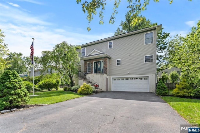 41 Sycamore Ave, Hillsdale, NJ 07642 - view of front facade with an attached garage, driveway, stairs, and a front yard