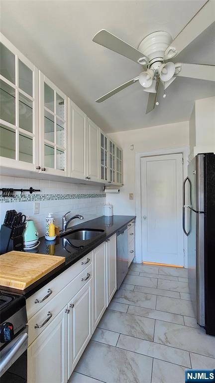 275 Engle St Unit G4, Englewood, NJ 07631 - kitchen with appliances with stainless steel finishes, a sink, ceiling fan, glass insert cabinets, and white cabinetry