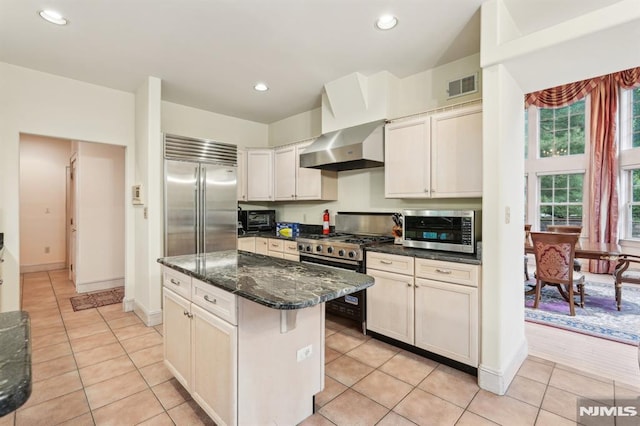 45 Dykers Farm Rd, North Haledon, NJ 07508 - kitchen featuring wall chimney exhaust hood, stainless steel appliances, a kitchen island, light tile patterned floors, and recessed lighting