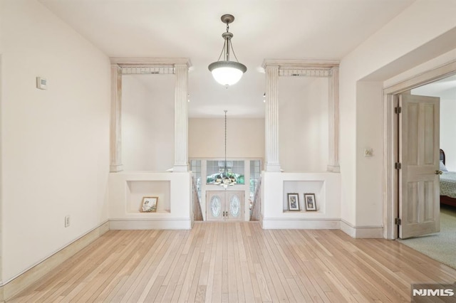 45 Dykers Farm Rd, North Haledon, NJ 07508 - unfurnished living room with hardwood / wood-style flooring, baseboards, and a chandelier