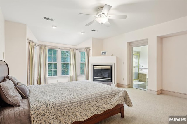 45 Dykers Farm Rd, North Haledon, NJ 07508 - carpeted bedroom with a glass covered fireplace, lofted ceiling, baseboards, a ceiling fan, and connected bathroom
