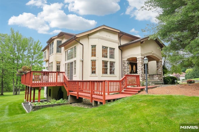 45 Dykers Farm Rd, North Haledon, NJ 07508 - rear view of house with stucco siding, stone siding, a wooden deck, and a lawn