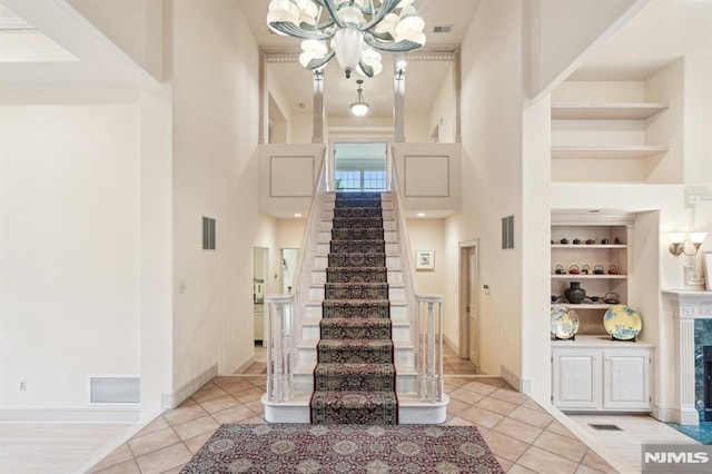 45 Dykers Farm Rd, North Haledon, NJ 07508 - foyer entrance featuring a high ceiling, a chandelier, light tile patterned flooring, stairway, and baseboards