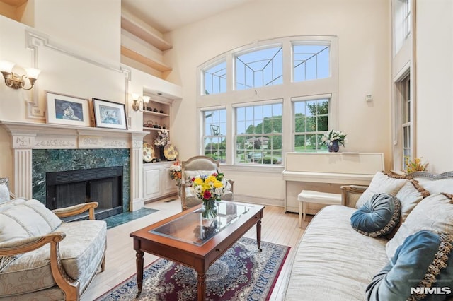 45 Dykers Farm Rd, North Haledon, NJ 07508 - living area with light wood-style floors, a fireplace, built in features, and a high ceiling