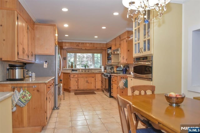 76 Spring Valley Rd, Montvale, NJ 07645 - kitchen featuring appliances with stainless steel finishes, crown molding, a sink, light countertops, and light flooring