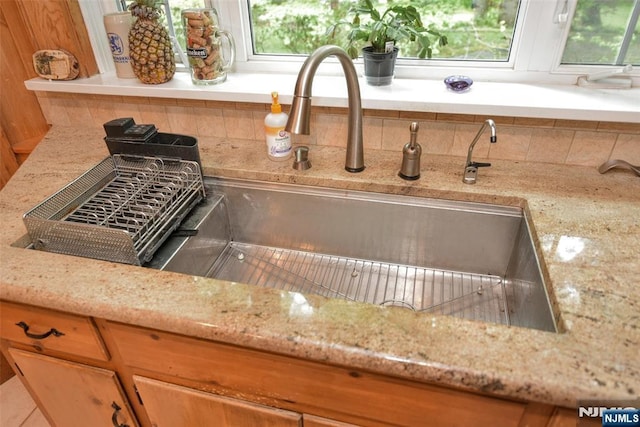 76 Spring Valley Rd, Montvale, NJ 07645 - kitchen view of decorative backsplash, light stone counters, and a sink