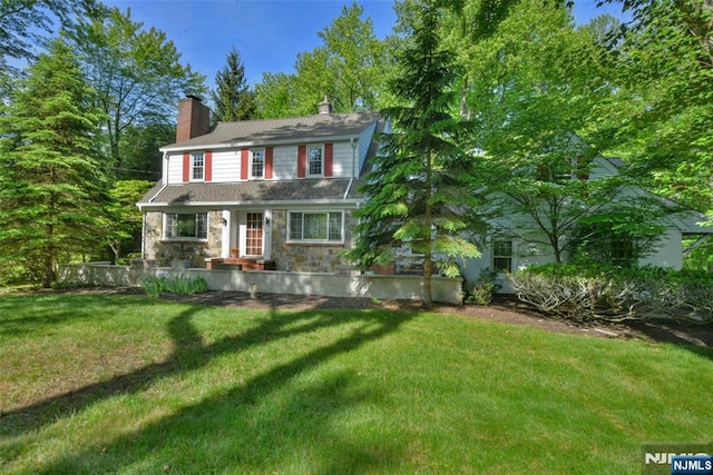 76 Spring Valley Rd, Montvale, NJ 07645 - view of front of property with a front yard, stone siding, and a chimney