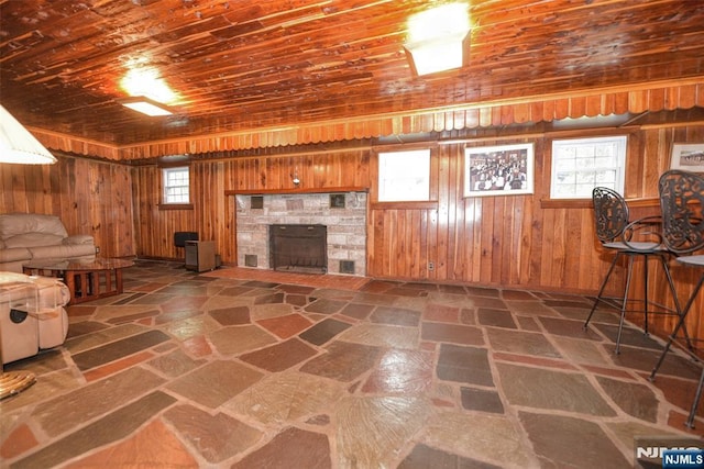 76 Spring Valley Rd, Montvale, NJ 07645 - unfurnished living room with wooden walls, a stone fireplace, and wood ceiling
