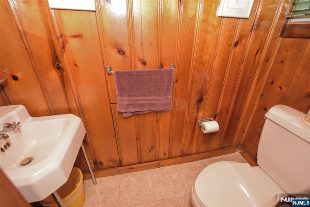 76 Spring Valley Rd, Montvale, NJ 07645 - bathroom with toilet, a sink, tile patterned floors, and wood walls