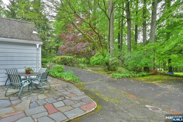 76 Spring Valley Rd, Montvale, NJ 07645 - view of patio / terrace featuring outdoor dining space and view of wooded area