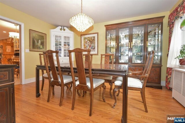 76 Spring Valley Rd, Montvale, NJ 07645 - dining room with a chandelier, radiator heating unit, light wood-type flooring, and baseboards