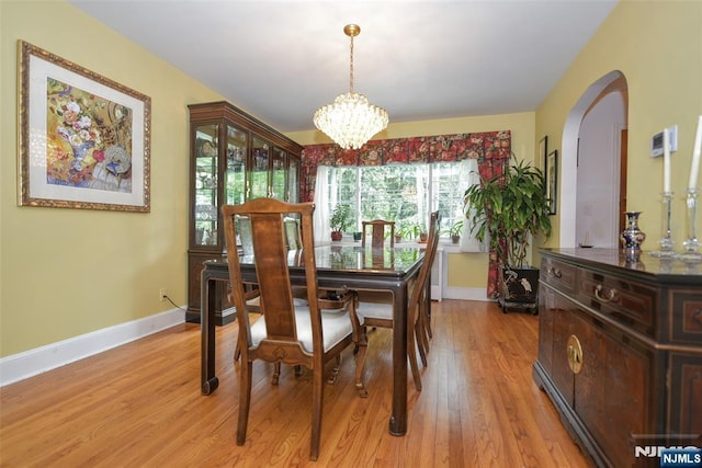 76 Spring Valley Rd, Montvale, NJ 07645 - dining space with arched walkways, a chandelier, baseboards, and light wood finished floors