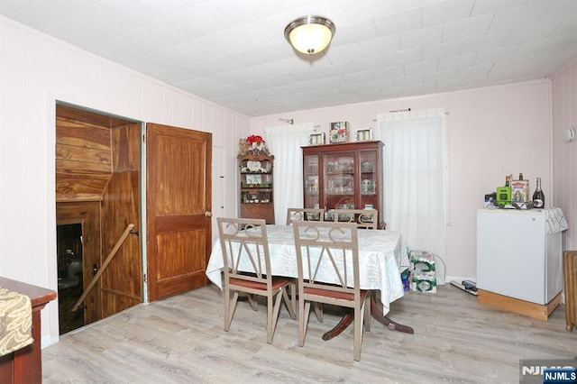 328-330 Hoover Ave, Bloomfield, NJ 07003 - dining area featuring light wood-style floors, ornamental molding, and wood walls