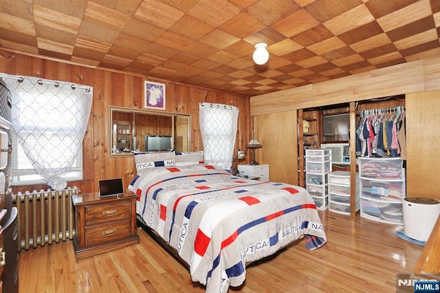 328-330 Hoover Ave, Bloomfield, NJ 07003 - bedroom featuring radiator, wooden walls, wood ceiling, and light wood-style floors