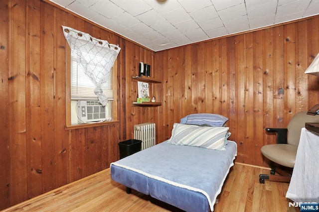 328-330 Hoover Ave, Bloomfield, NJ 07003 - bedroom with radiator heating unit, wood walls, cooling unit, and wood finished floors