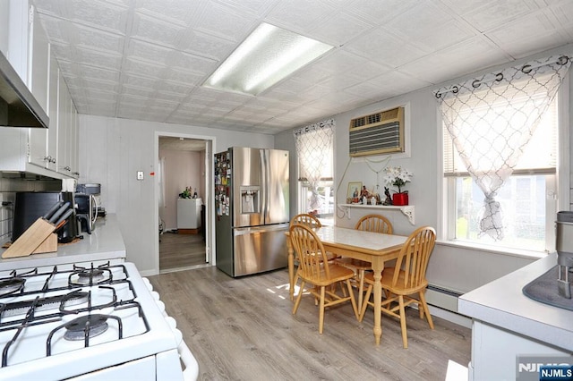 328-330 Hoover Ave, Bloomfield, NJ 07003 - kitchen featuring stainless steel fridge with ice dispenser, gas range gas stove, wall chimney exhaust hood, a wall mounted air conditioner, and light countertops