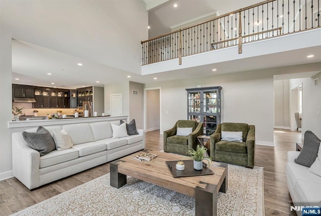 15 Meadowbrook Rd, Upper Saddle River, NJ 07458 - living area with a high ceiling, wood finished floors, baseboards, recessed lighting, and healthy amount of natural light