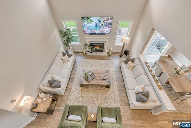 15 Meadowbrook Rd, Upper Saddle River, NJ 07458 - living room featuring wood finished floors, a glass covered fireplace, and a high ceiling