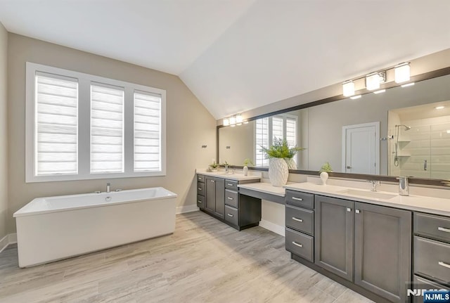 15 Meadowbrook Rd, Upper Saddle River, NJ 07458 - full bathroom with vanity, a shower stall, wood finished floors, a freestanding bath, and vaulted ceiling