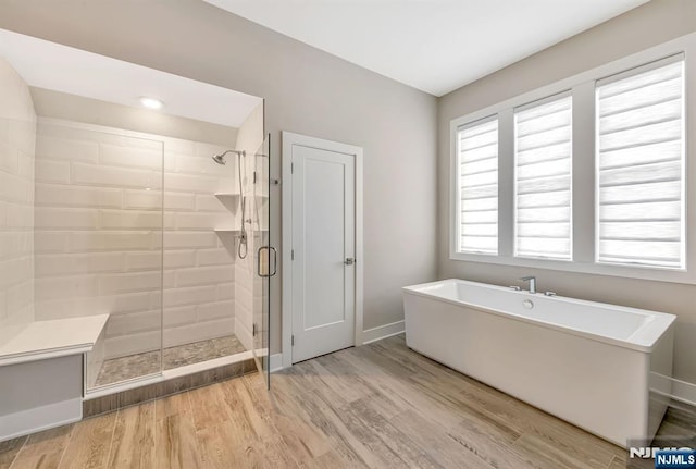 15 Meadowbrook Rd, Upper Saddle River, NJ 07458 - full bath with a soaking tub, a shower stall, wood finished floors, and baseboards