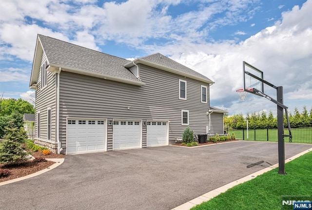 15 Meadowbrook Rd, Upper Saddle River, NJ 07458 - view of side of home with driveway, roof with shingles, and an attached garage
