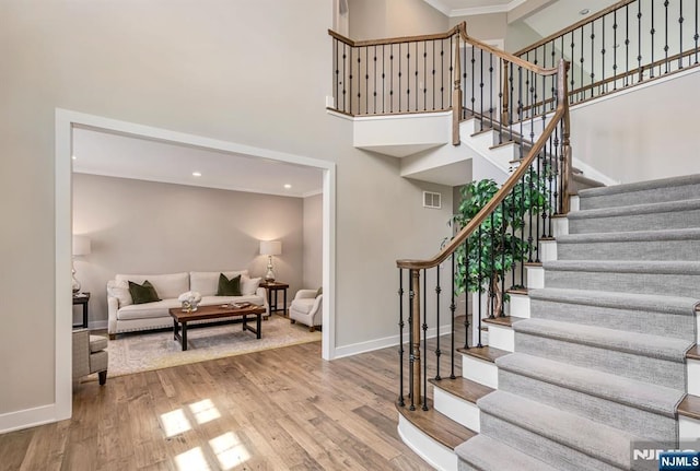 15 Meadowbrook Rd, Upper Saddle River, NJ 07458 - stairs featuring a towering ceiling, baseboards, crown molding, wood finished floors, and recessed lighting