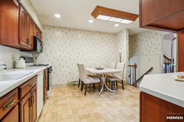 526 Cleveland Ave, River Vale, NJ 07675 - kitchen with wallpapered walls, range, a sink, light countertops, and black microwave