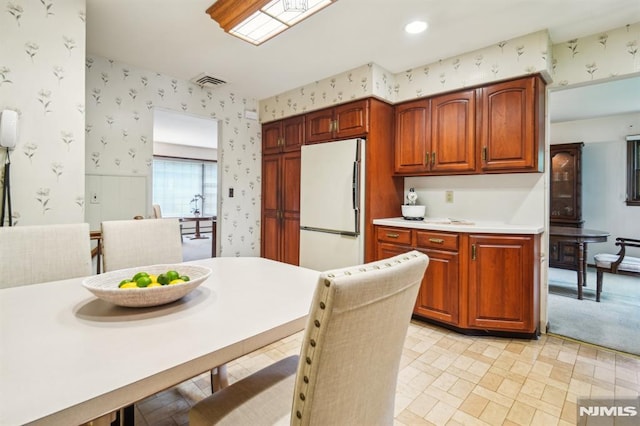 526 Cleveland Ave, River Vale, NJ 07675 - kitchen with freestanding refrigerator, wallpapered walls, light countertops, and brown cabinets
