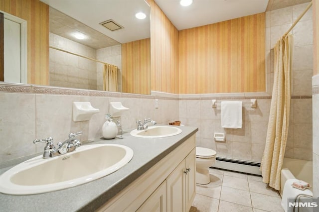 526 Cleveland Ave, River Vale, NJ 07675 - full bath featuring baseboard heating, toilet, double vanity, tile walls, and tile patterned flooring